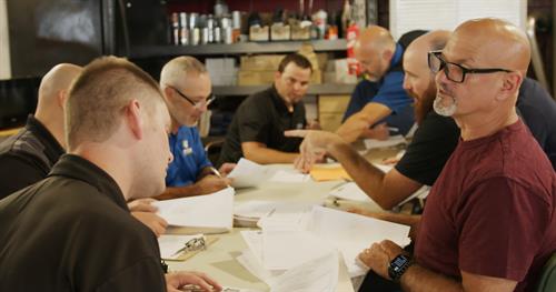 Gear Performance Group Members compare notes on their evaluation of a members shop