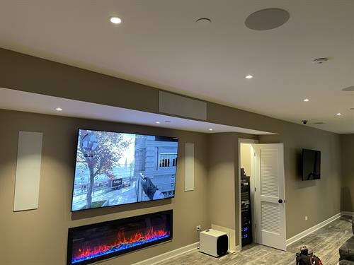 Small custom entertainment system with low voltage lighting system in customers basement.