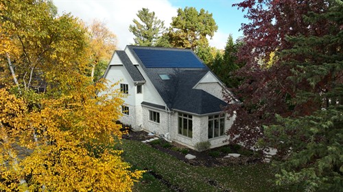 In addition to conventional asphalt roofing, Sun Vault Roofing is the only contractor in Wisconsin offering integrated solar shingle roofing systems. Solar shingles, as seen on this home in Oconomowoc, WI lie flat against the roof deck, improving curb appeal.