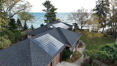In addition to conventional asphalt roofing, Sun Vault Roofing is the only contractor in Wisconsin offering integrated solar shingle roofing systems. Solar shingles, as seen on this lakefront home in Sheboygan, WI, create a premium, luxury aesthetic with no visible wires or racks.