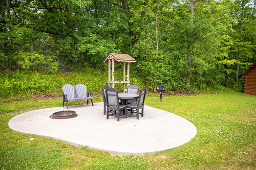Tent site with water, electricity, seating and fire ring.