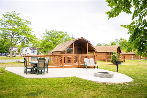 Camping Cabin with patio, furniture, grill and fire ring.