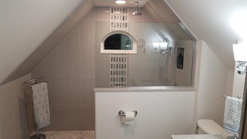 Bathroom in Attic Space with Slanted Ceilings Due to Roof