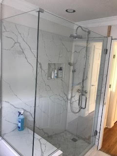 Custom frameless shower door and panel with 90 degree return panel