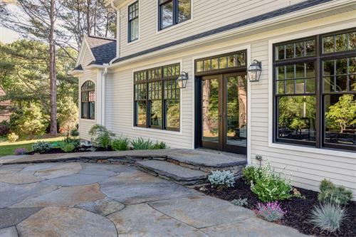 Cottage-style windows and Goshen Stone patio add charm