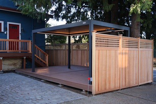Low-maintenance composite decking paired with a custom pergola
