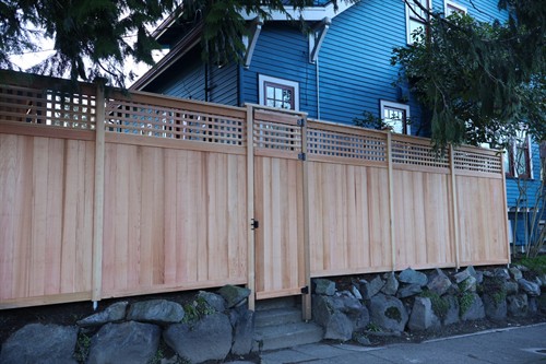 Custom cedar privacy fence with lattice detail and integrated gate