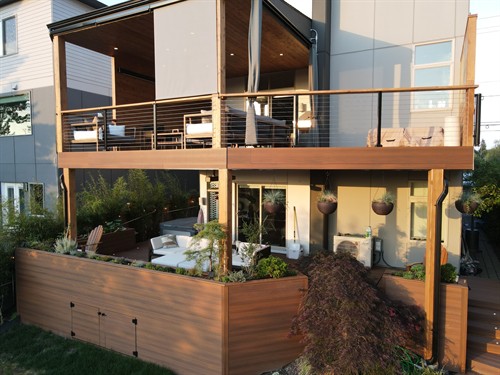 Custom multi-level deck with cable railing and integrated privacy features