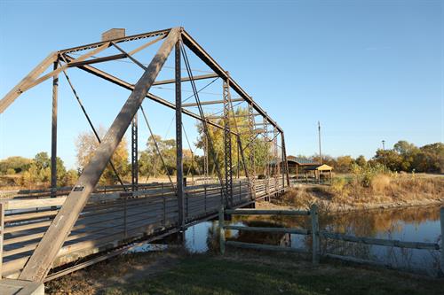 The old railroad bridge leading to the pavilion and sod house