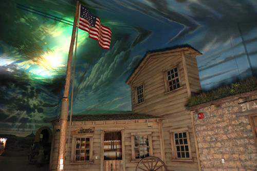 FORT KEARNY As you pass through the "wagon train video", you enter Fort Kearny. You see a stockade style fence, and the log-cabin style buildings of the Fort.