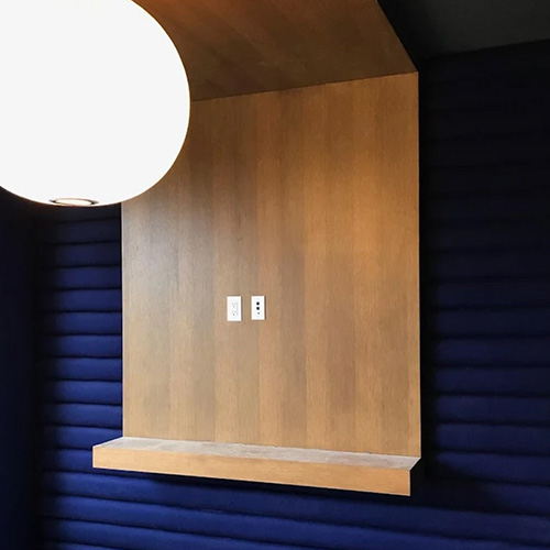 RLX Design - noise suppressing uphlostered walls, lighting, and custom millwork to hold this conference room television