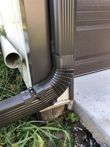 Hinged Downspout Extension (1 of 2): Allows them to be picked up for mowing.