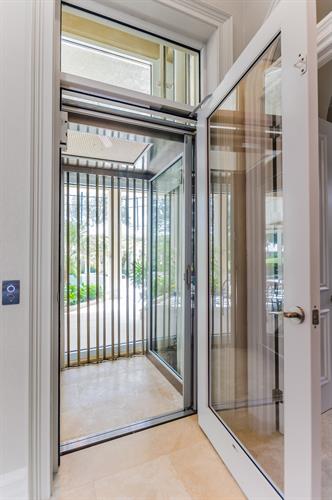 Custom built home elevator with glass.