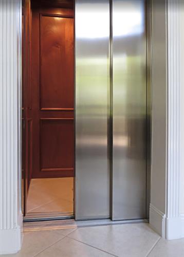 Custom built home elevator with commercial doors.