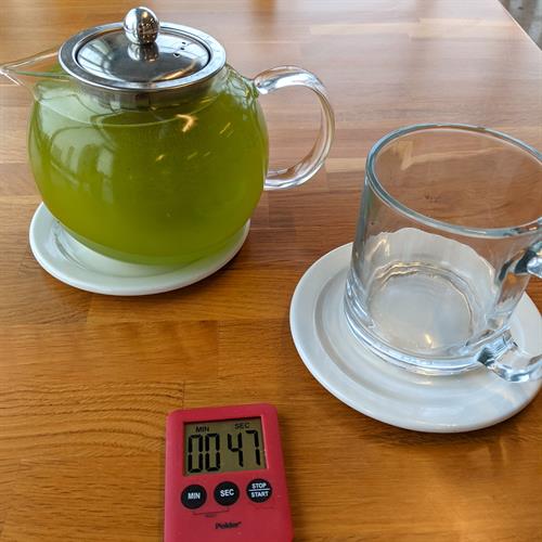 A pot of tea with timer at Cultivate Taste Tea Salon