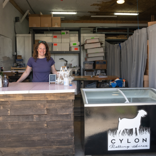 Leslie, who owns Cylon Rolling Acres, stands at the pickup counter in the farm pack shed.