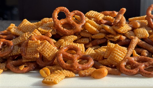 Jen's Heatmix is a sweet and spicy combination of rice cereal, pretzels, sesame sticks and hot pepper peanuts coated in a blend of butter, brown sugar and sriracha.