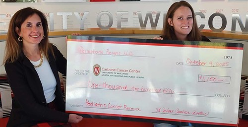 Janie Winston and Alyssa Doering in October 2025 with a donation for Pediatric Cancer research