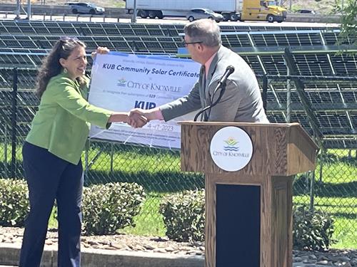 Knoxville Mayor Indya Kincannon accepts first shares of KUB Community Solar from KUB CEO Gabriel Bolas