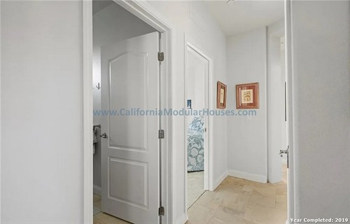 Hallway with white walls and doors.  California Modular Houses. Modular home construction California.  Prefab house.  Oxnard, Ventura County, CA.   