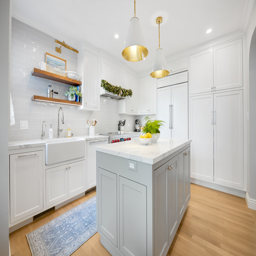 We designed this custom kitchen for our 27th Ave. renovation in San Francisco, combining bright cabinetry, open shelving, and a functional island to create a warm and inviting space.