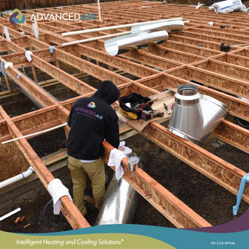 HVAC Installer Working on a Residential Underfloor Duct System