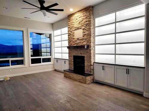 Stone Fireplace with lighted custom cabinetry