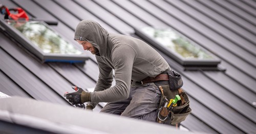 Roofer working on new metal roof in Jacksonville