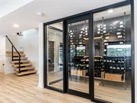 Waterfront Contemporary Home Wine Room & Floating Stairs