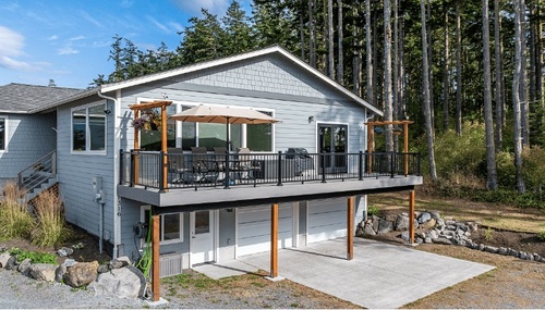 Custom home construction completed by Kings-Men Construction on Whidbey Island, featuring a spacious elevated deck and quality exterior craftsmanship.