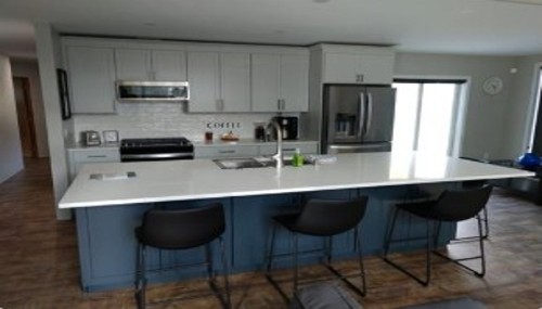 Kitchen remodeling project in Bellingham, WA with custom cabinetry, quartz countertops, and island seating.