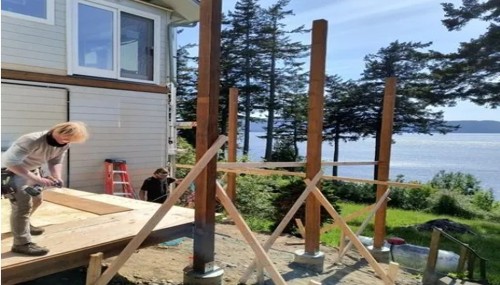 Custom waterfront deck construction by Alderwood Builders LLC featuring structural framing and premium craftsmanship overlooking the Puget Sound near Bellingham, WA.