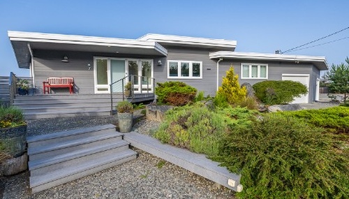 Complete home remodeling project completed by Kingsmen Painting, transforming this Whidbey Island home with updated exterior finishes and modern design features.