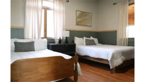 Cozy home renovation featuring a refreshed bedroom design with warm wood flooring and modern comfort. Cozy home renovation featuring a refreshed bedroom design with warm wood flooring and modern comfort.