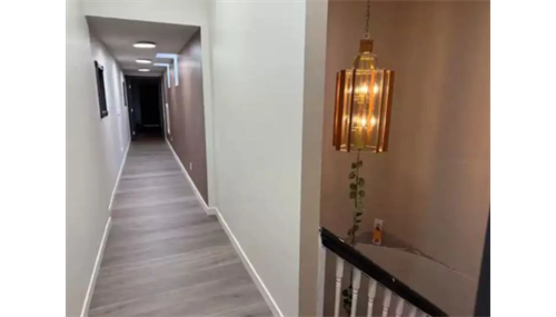 Modern hallway remodel with stylish lighting and high-quality flooring for a sleek, updated home interior. Modern hallway remodel with stylish lighting and high-quality flooring for a sleek, updated home interior.