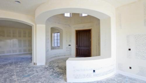 Water-damage drywall repair and replacement inside a home featuring moisture-affected sheetrock and restoration work.