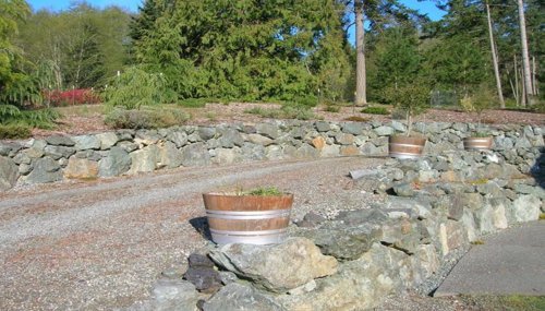 Natural stone walkway and custom landscaping design completed in Oak Harbor, WA to enhance outdoor functionality and visual appeal.