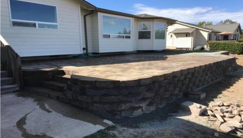 Custom paver patio with retaining wall installation in Anacortes, WA built for outdoor entertaining and improved yard grading.