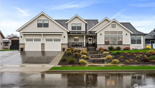 Modern custom home in Lynden, WA featuring landscaped front yard and spacious three-car garage in a desirable Skagit County neighborhood.