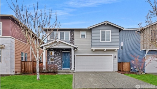 Two-story family home in Bothell, WA neighborhood featuring attached garage and modern siding.