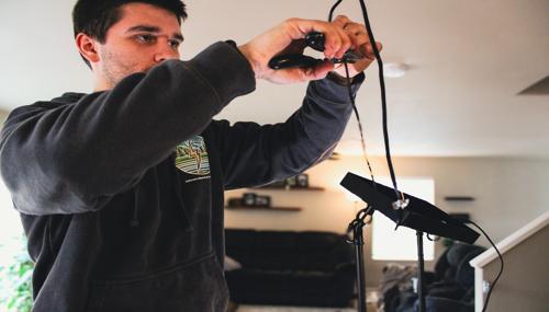 Skagit Valley electrician installing lighting fixture and handling electrical wiring for residential home by Johnson Electrical Services
