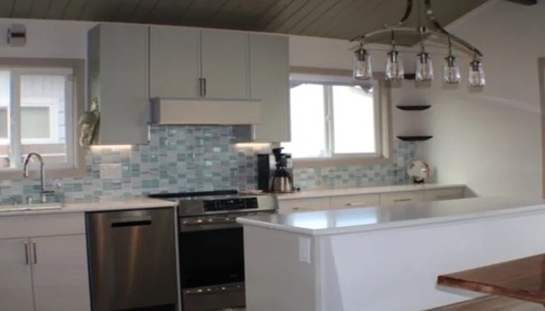 Contemporary kitchen remodeling project with custom cabinetry, upgraded lighting, and modern finishes.