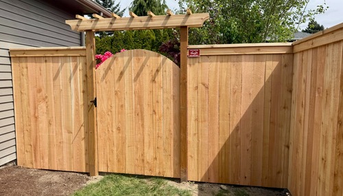Custom cedar privacy fence and arched gate installed by C&W Fencing for a residential property in Mount Vernon, WA.