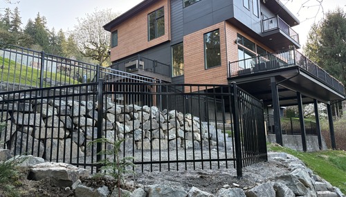 Black ornamental metal fence and gate installed by C&W Fencing for a modern residential property in Skagit County, WA.