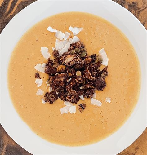 Cacao Grounded Granola on a Pumpkin Smoothie Bowl with Coconut Chips