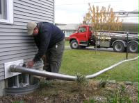Bulk pellet delivery in action - the driver attaches a pneumatic hose to permanent piping connected to storage containers in your basement or garage and quickly fills the containers.