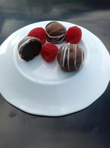 chocolates surrounded by raspberries