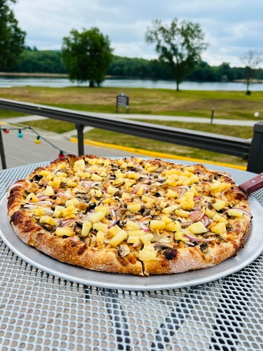 Pineapple on Pizza at outdoor table at Riviera Bowl & Pizzeria