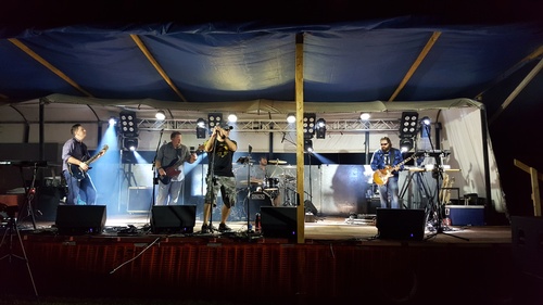 Band performing on outdoor stage at Cow Chip festival