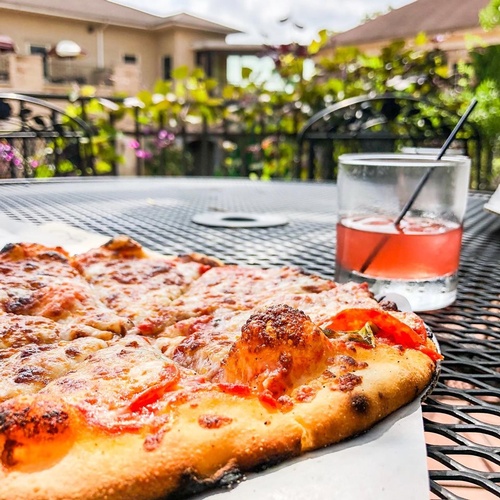 Pizza and a cocktail at outdoor patio table at Wollersheim Winery